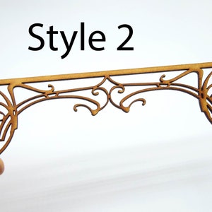 May include: Style 2 wooden decorative arch with a detailed intricate design. The arch is made of wood and has a light brown color.