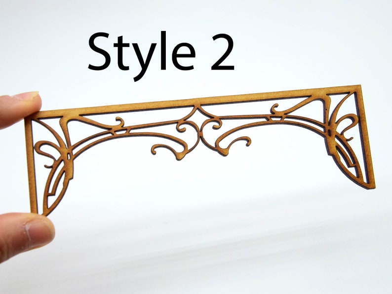 May include: Style 2 wooden decorative arch with a detailed intricate design. The arch is made of wood and has a light brown color.