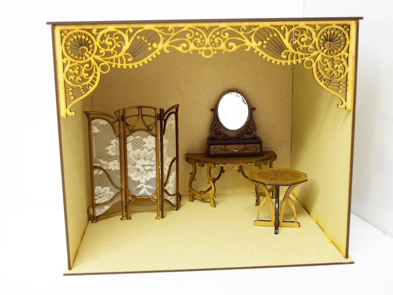 May include: A miniature dollhouse room with a wooden screen, a vanity table with a mirror, and a small round table. The room is decorated with intricate wooden details and a light brown background.