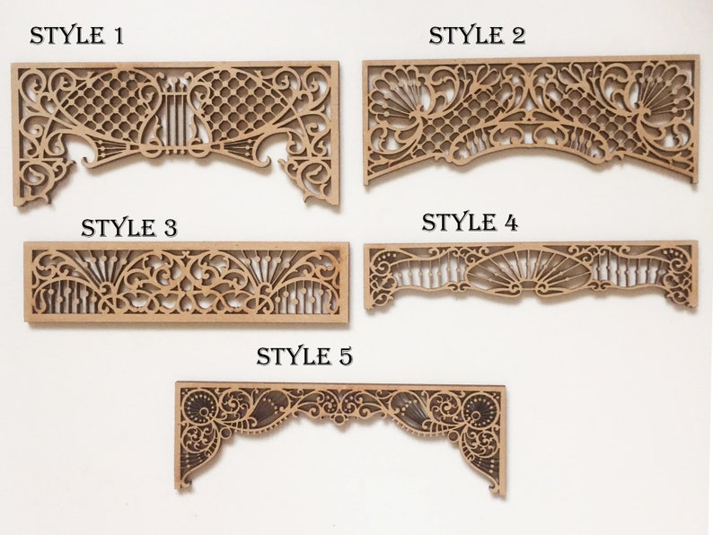 May include: Five different styles of decorative wooden wall panels with intricate cut-out designs. The panels are made of light brown wood and have a variety of floral and geometric patterns.