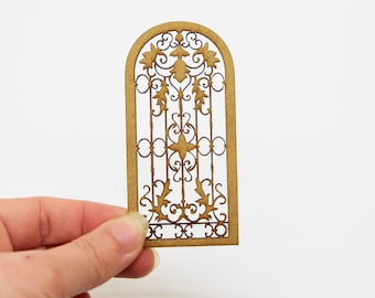 May include: A wooden cutout of a decorative arched window with a detailed, intricate design. The window is made of wood and has a brown color.