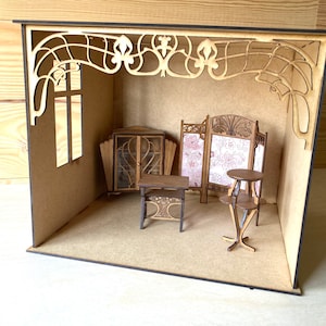 May include: A miniature dollhouse room with wooden furniture, including a bookcase, a table, and a screen. The room has a decorative wooden archway and a window.