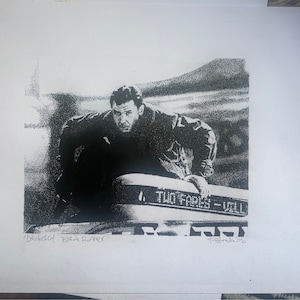 May include: Black and white print of a man in a jacket, looking over his shoulder, with the text "Two Fares - Yellow" on a sign behind him. The print is titled "Deckard - Blade Runner".