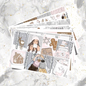 May include: A set of winter-themed planner stickers featuring illustrations of a gingerbread house, a woman holding a mug, a car with gifts, a mug with marshmallows, and a deer. The stickers are on a white background with a gray and white pattern.