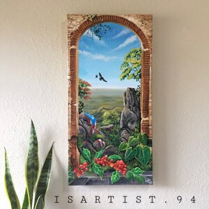 May include: A painting of a landscape scene through an arched window. The scene includes a rocky hillside, green trees, a blue sky with white clouds, and a Puerto Rican flag. The painting is framed in a brown wooden frame.