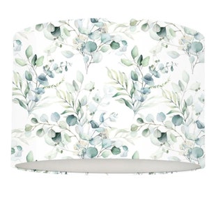 May include: A white lampshade with a repeating pattern of green and blue watercolour leaves and branches.