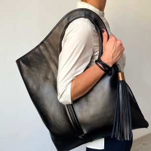 Oversized leather bag Black hobo purse with bronze interior Large laptop bag for women Genuine leather shopper with a tassel Armhole bag