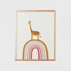 May include: A framed print of a giraffe standing on a rainbow. The giraffe is brown with dark spots and has a long neck. The rainbow is multi-colored with shades of blue, pink, and orange.