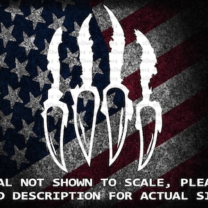 May include: White silhouette of five stylized knife blades against a red, white, and blue American flag background. The text "DECAL NOT SHOWN TO SCALE, PLEASE READ DESCRIPTION FOR ACTUAL SIZE!" is at the bottom of the image.