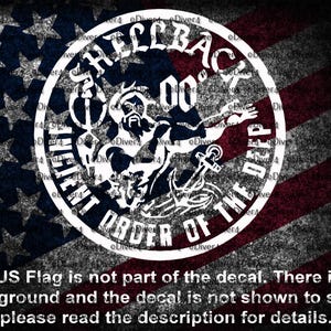May include: A white decal with the text "SHELLBACK" and "ANCIENT ORDER OF THE DEEP" in a circular design. The image includes a stylized illustration of a figure with an anchor. The background features a distressed American flag.