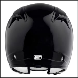 May include: Black motorcycle helmet with a white DOT sticker on the back.