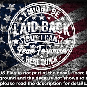 May include: A graphic design featuring the text "I MIGHT BE LAID BACK BUT I CAN LEAN FORWARD REAL QUICK" in a white circular design, set against a distressed American flag background. The image includes stars and stripes.