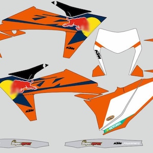 May include: An assortment of orange, white, and navy blue motorcycle decals. The decals feature the Red Bull logo, KTM branding, and the Motorex logo. The design includes various shapes and sizes, suitable for different parts of a motorcycle.