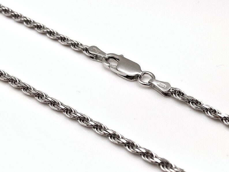 May include: A silver rope chain necklace with a lobster clasp.