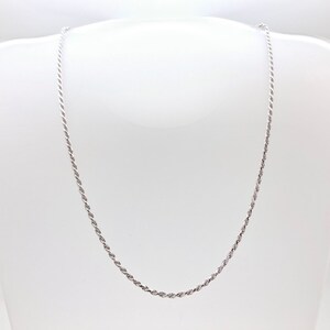 May include: A silver rope chain necklace. The chain is made of a twisted rope design.
