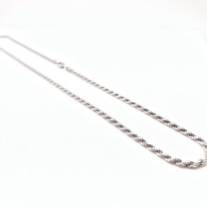 May include: A silver rope chain necklace. The chain is made of a twisted rope design.