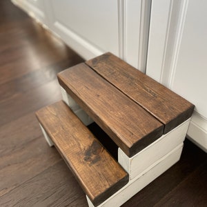 Wooden step stool, dark walnut stained steps with rustic white painted supports, personalized name hand painted on step, step stool in a kitchen, step stool against cabinet, kids step stool, adult weight