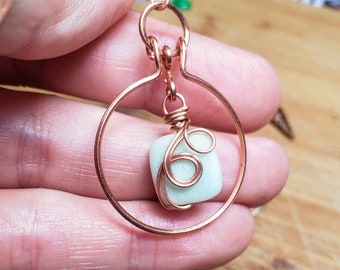 Copper wire wrapped circle earrings with semiprecious bead in center