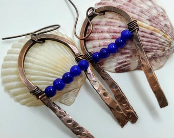 Hammered copper earrings, blue beads across the main U shape