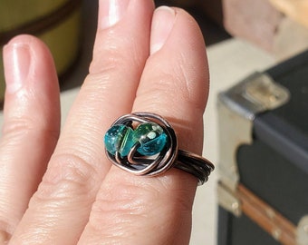 Antique finished copper wire wrapped ring with green and silver glass beads