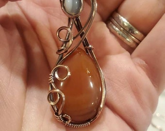 Banded carnelian, white and clear quartz and oxidized copper wore wrapped pendant