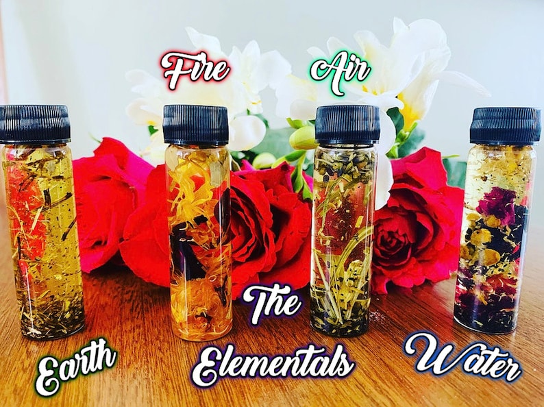May include: Five small glass bottles with black caps filled with a clear liquid and various dried flowers and herbs. The bottles are labeled "Earth", "Fire", "Air", "Water", and "The Elementals".
