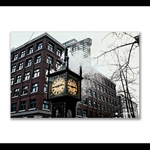 May include: A vintage clock tower with a gold face and black hands, emitting steam from the top, in front of a brick building with a cloudy sky in the background.