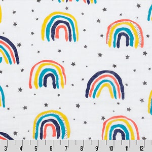 May include: White fabric with a repeating pattern of colorful rainbows and silver stars.