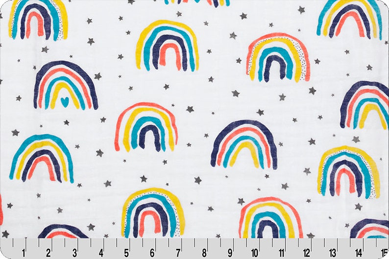May include: White fabric with a repeating pattern of colorful rainbows and silver stars.