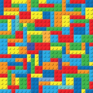 May include: A pattern of interlocking plastic building blocks in primary colors including red, blue, yellow, green, and orange. The rectangular and square blocks are arranged in a dense, grid-like mosaic, each featuring circular studs on top.