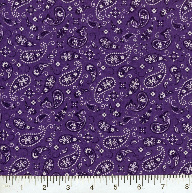 May include: Purple fabric with a white paisley pattern. The fabric is 8 inches wide.