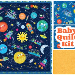 May include: A colorful baby quilt kit featuring a whimsical space theme. The design includes planets, rockets, spaceships, and smiling suns and moons against a dark blue background. The words "Baby Quilt Kit" are displayed in orange and white.