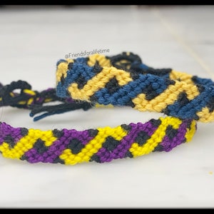 May include: Two handmade friendship bracelets. One bracelet features a pattern of yellow, purple, and black. The other bracelet has a pattern of yellow, blue, and black. The bracelets are made of woven thread. The text "@friendsforalifetime" is visible.
