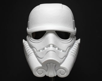 May include: White plastic Stormtrooper helmet with a detailed design. The helmet has a visor and a textured surface.