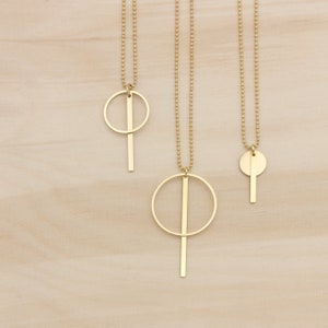 Oi. Bar and circle geometric brass necklace with a high recycled content image 1
