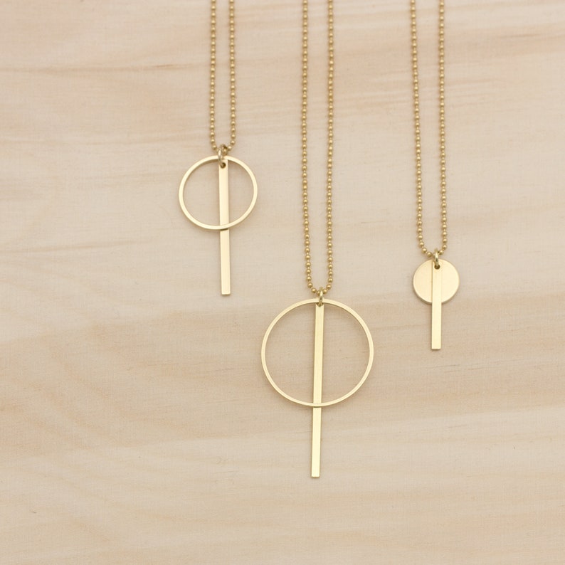 Oi. Bar and circle geometric brass necklace with a high recycled content image 1