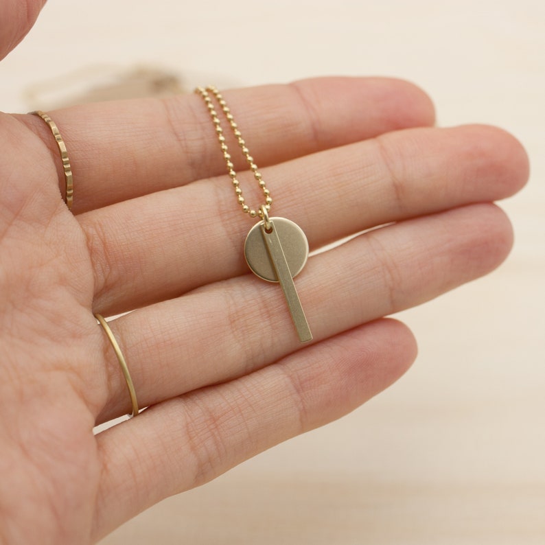 Oi. Bar and circle geometric brass necklace with a high recycled content image 6
