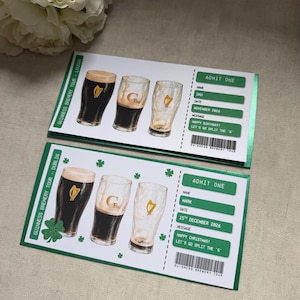 May include: Two rectangular paper tickets for a Guinness Brewery Tour. Each ticket features three beer glasses, green shamrocks, and text including ADMIT ONE, names, dates, and messages. The design uses white, dark green, and black ink colours.