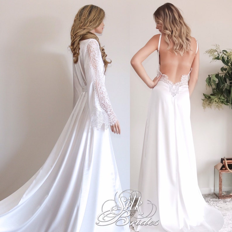 May include: Two white satin robes with lace detailing. One robe has long sleeves and a tie at the waist. The other robe has spaghetti straps and a low back.
