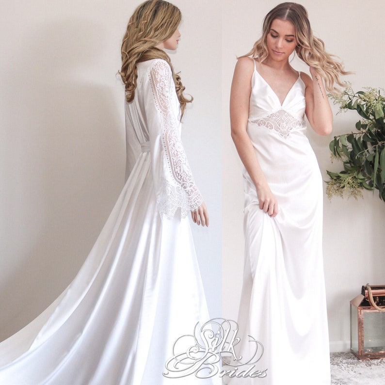 May include: Two white satin robes with lace detailing. One robe has long sleeves with lace trim and the other has spaghetti straps with lace trim.