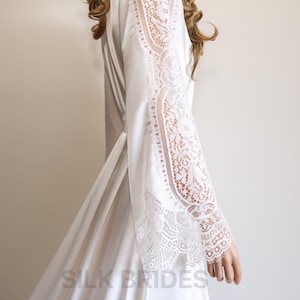May include: White satin robe with lace trim on the sleeves. The robe has a tie belt and is made of soft, luxurious fabric. The text "SILK BRIDES" is visible at the bottom of the image.