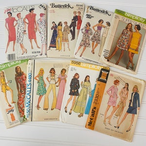 May include: A collection of vintage sewing patterns for women's clothing. The patterns are from McCall's and Simplicity brands and feature a variety of styles, including dresses, skirts, and tops. The patterns are in various colours, including yellow, pink, blue, and green.
