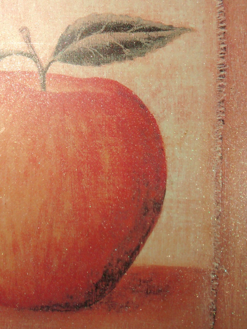 May include: A red apple with a green leaf on top, painted on a textured background.
