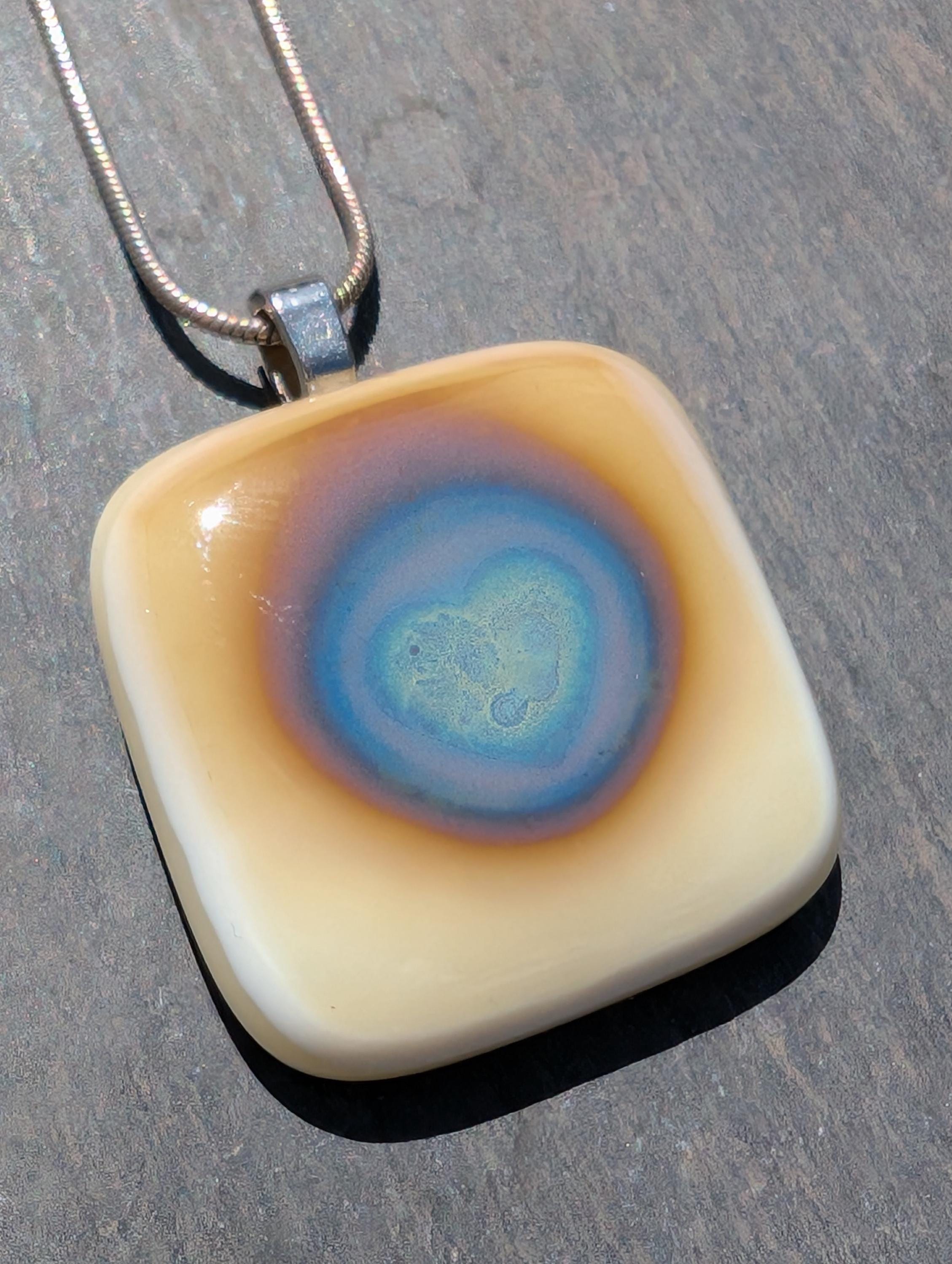 Amazing unique reactions in cream glass and silver leaf pendant, stunning silver reactions and hues in these heart glass necklace.
