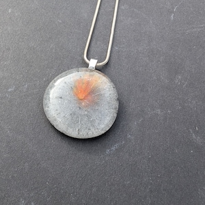A beautiful glass necklace. Amazing circular glass pendant with grey and orange colours. Stunning special glass pendant and jewellery.