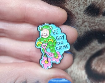 Be Gay Do Crime Frog on Bike  Kitsch Kewpie Enamel Pin Badge  25mm Queer Pride Anti Fascist