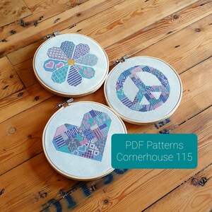 May include: Three embroidery hoop patterns with a peace sign, a heart, and a flower. The patterns are all in shades of blue, pink, and purple. The text "PDF Patterns Cornerhouse 115" is visible in the bottom right corner.