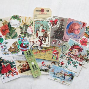 May include: A collection of vintage Christmas themed paper ephemera, including cards, tags, and stickers. The images feature Santa Claus, reindeer, snowmen, and other holiday imagery. The paper is in various shades of red, green, blue, and white.