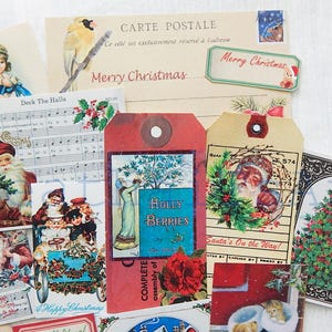 May include: Assortment of vintage Christmas themed paper ephemera, including a postcard with the text "Merry Christmas", a tag with the text "Holly Berries", a tag with the text "Santa's On the Way!" and a sheet of music with the text "Deck The Halls".