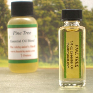 May include: Two glass bottles of Pine Tree essential oil blend. The smaller bottle is 1/4 oz and the larger bottle is 1 oz. Both bottles have green labels with white text.
